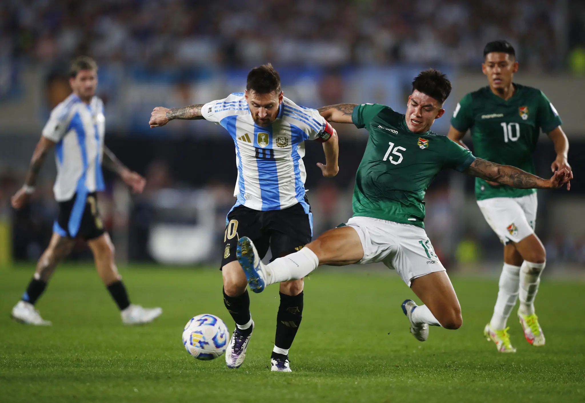 Soccer Football - World Cup - South American Qualifiers - Argentina v Bolivia - Estadio Mas Monumental, Buenos Aires, Argentina - October 15, 2024 Argentina's Lionel Messi in action with Bolivia's Gabriel Villamil REUTERS/Matias Baglietto
